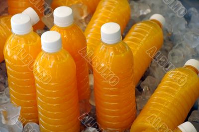 Bottles of Fresh Orange Juice on Ice