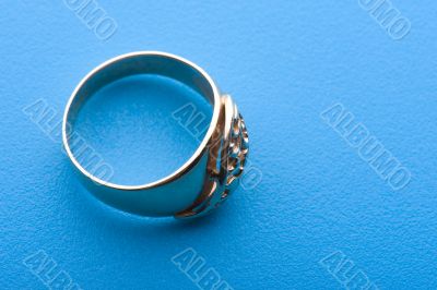 Gold ring macro on blue