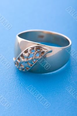 Gold ring on blue