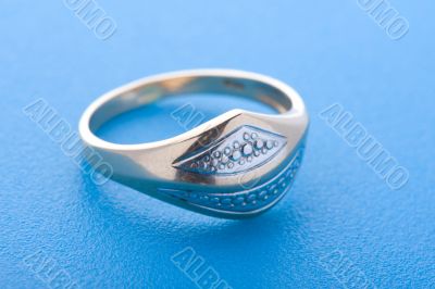 Gold ring on blue background