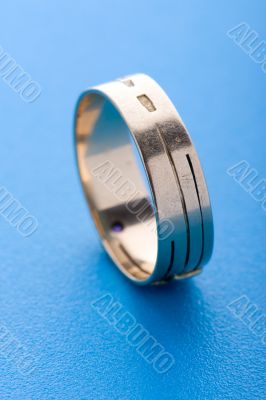 Gold ring on blue background macro