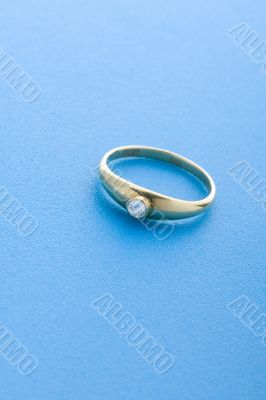 Gold ring on blue close up