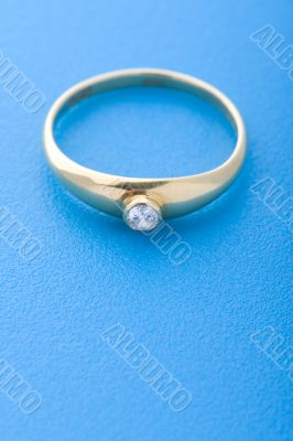 Gold ring on blue macro