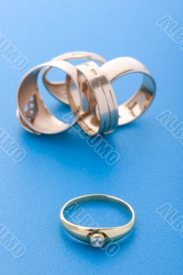 Gold rings on blue