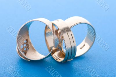 Gold rings on blue background