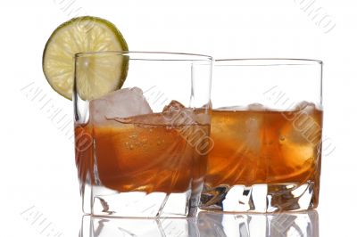 glass of whiskey with ice cubes on white