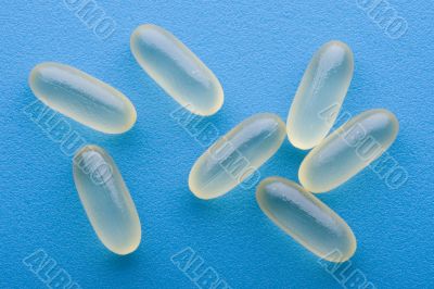 Medical pill on blue background