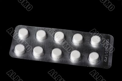Medical tablet on black