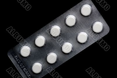 Medical tablet on black macro