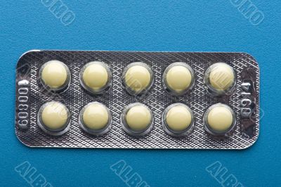 Medical tablet on blue close up
