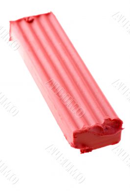 Red plasticine on white macro