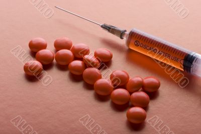 Red Tablet and syringe on red