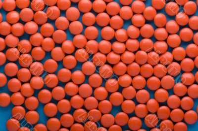Red Tablet on blue close up