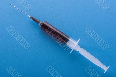 syringe on blue