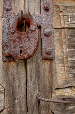 Padlock And Handle On Wooden Gate