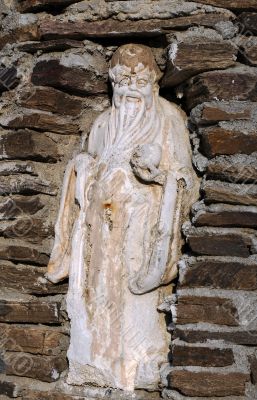 Old Man Statue in the Brick Wall