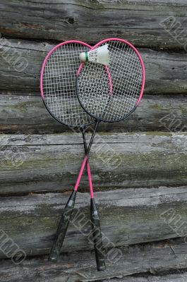 Badminton Rackets and Birdie on the Wooden Wall