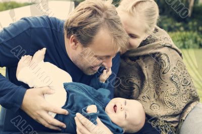Happy family sitting on the grass