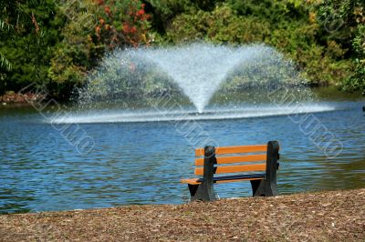 Fountain on a pond with bench