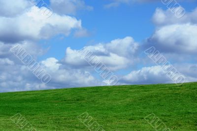 Field and cloudy sky
