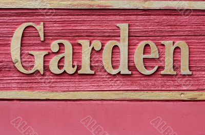 Red wooded garden sign