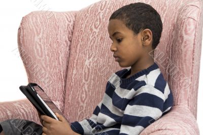 Young boy studying on a tablet PC
