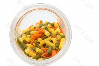 Colorful raw fusilli in a jar