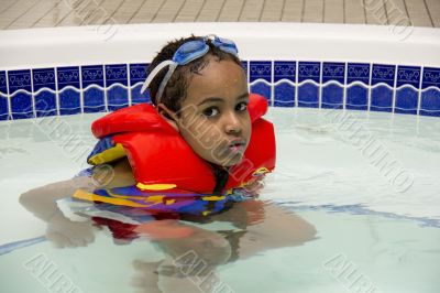 A young boy soaking in a hot tub