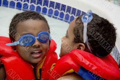 Two brothers playing in the pool