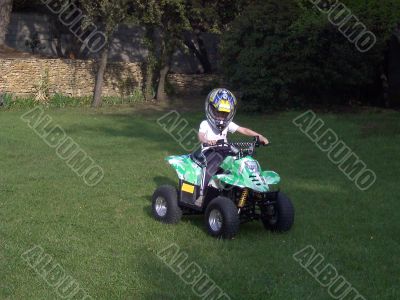 boy riding little quad bike