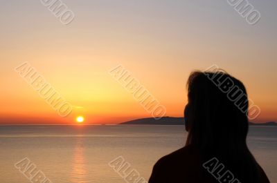 Woman`s Silhouette and the Rising Sun