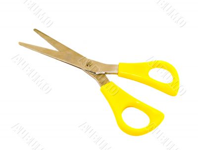 Yellow scissors on a white background