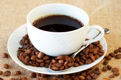 Cup of coffee with coffee beans