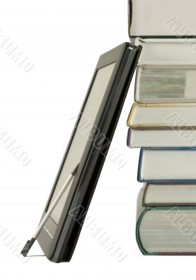 Stack of books and electronic book reader