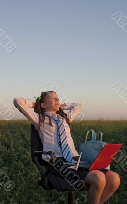 Teen girl sitting with a laptop