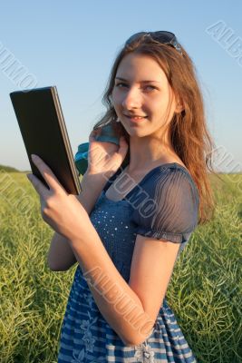 Teen girl with electronic book reader