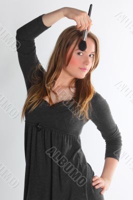 The girl the visagiste in a gray dress
