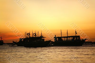 Drifting boat on a sunset