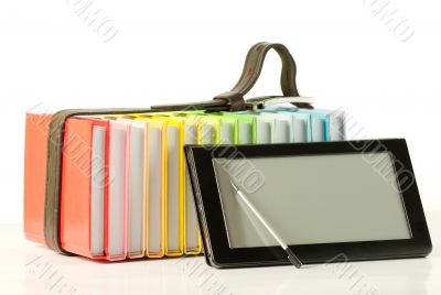 Stack of colorful books and electronic book reader