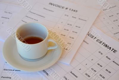 Half Empty Cup of Tea on Financial Documents