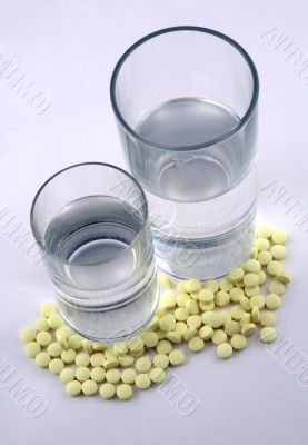 Tablets and a glass