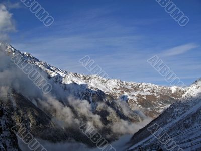Mountain under the blue sky and the clouds