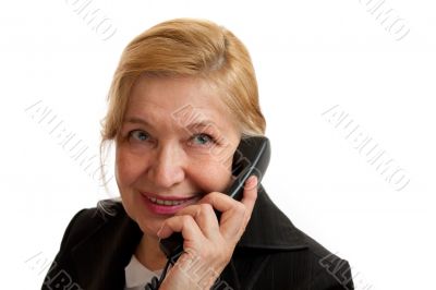 Senior Woman talking on the phone in black suite.