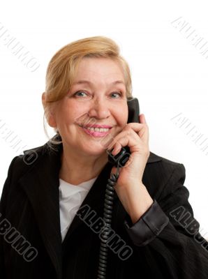 Senior Woman talking on the phone in black suite.