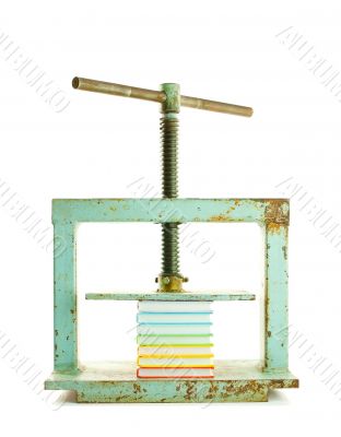 Pile of colourful books under the press