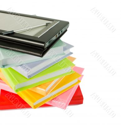 Stack of books and electronic book reader
