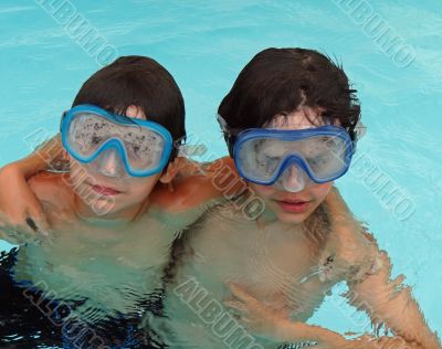 two boys with goggles in swimming pool