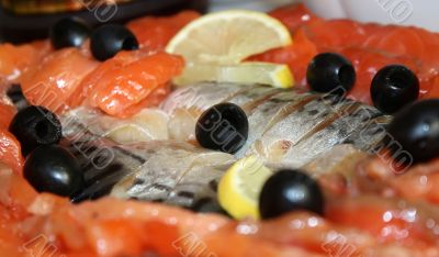 Cutting the fish, lemon and olives