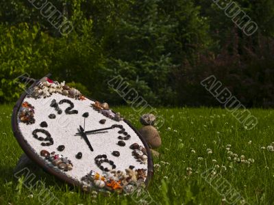 Green landscape with wall clocks