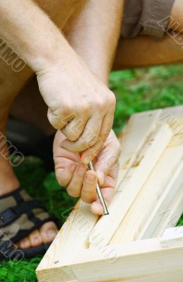 Man`s hands on a screwdriver